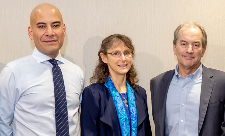 Fady Jameel standing next to Renee Robins and John Lienharrd against blank wall