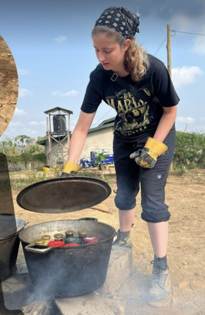 Katana Finlason boils beeswax in jars in a large cast iron pot to make "thermal batteries"