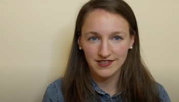 White woman with long brown hair smiling