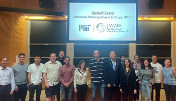 Group photo of the Epic research team and staff in front of a projector screen in a lecture hall