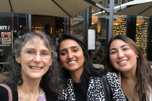 A selfie of Renee Robins (left), Shubhi Goyal (center), and Daniela Morales (right), in front of a restaurant