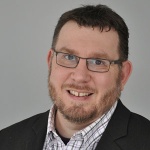 White man with beard and glasses smiling