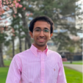 Arjav Shah standing in a park with plants behind him